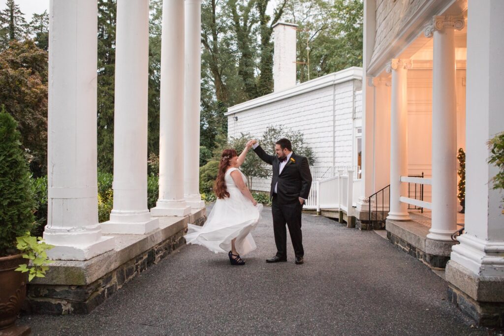 groom spinning bride at mansion