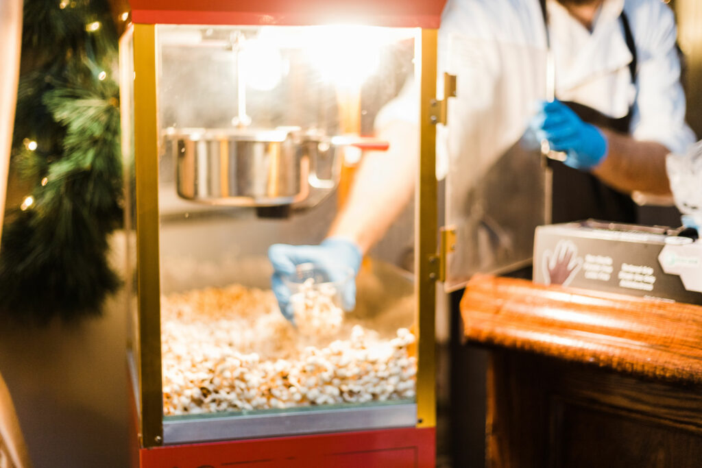 man serving from popcorn machine