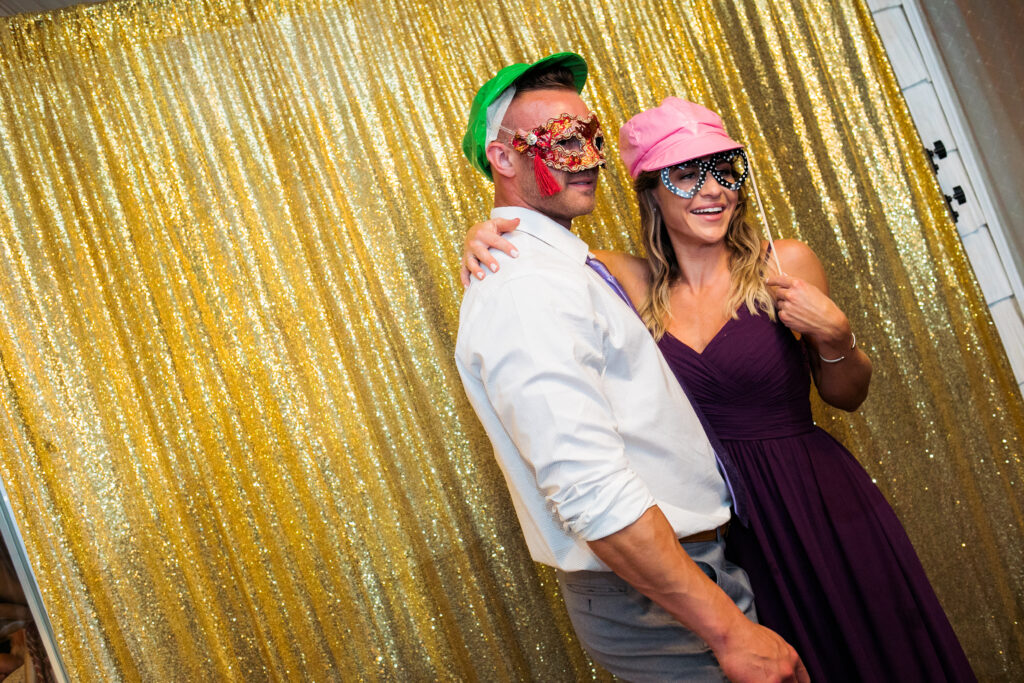 masked wedding guests in photo booth