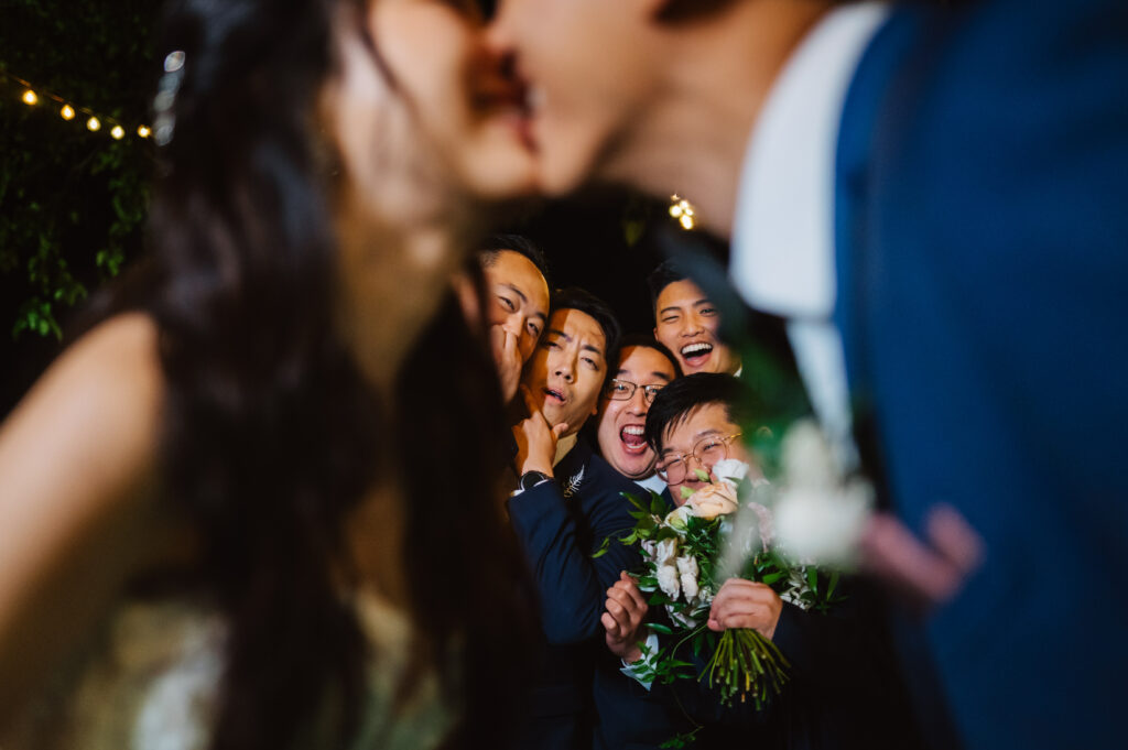 crowd spying on wedding couple kiss