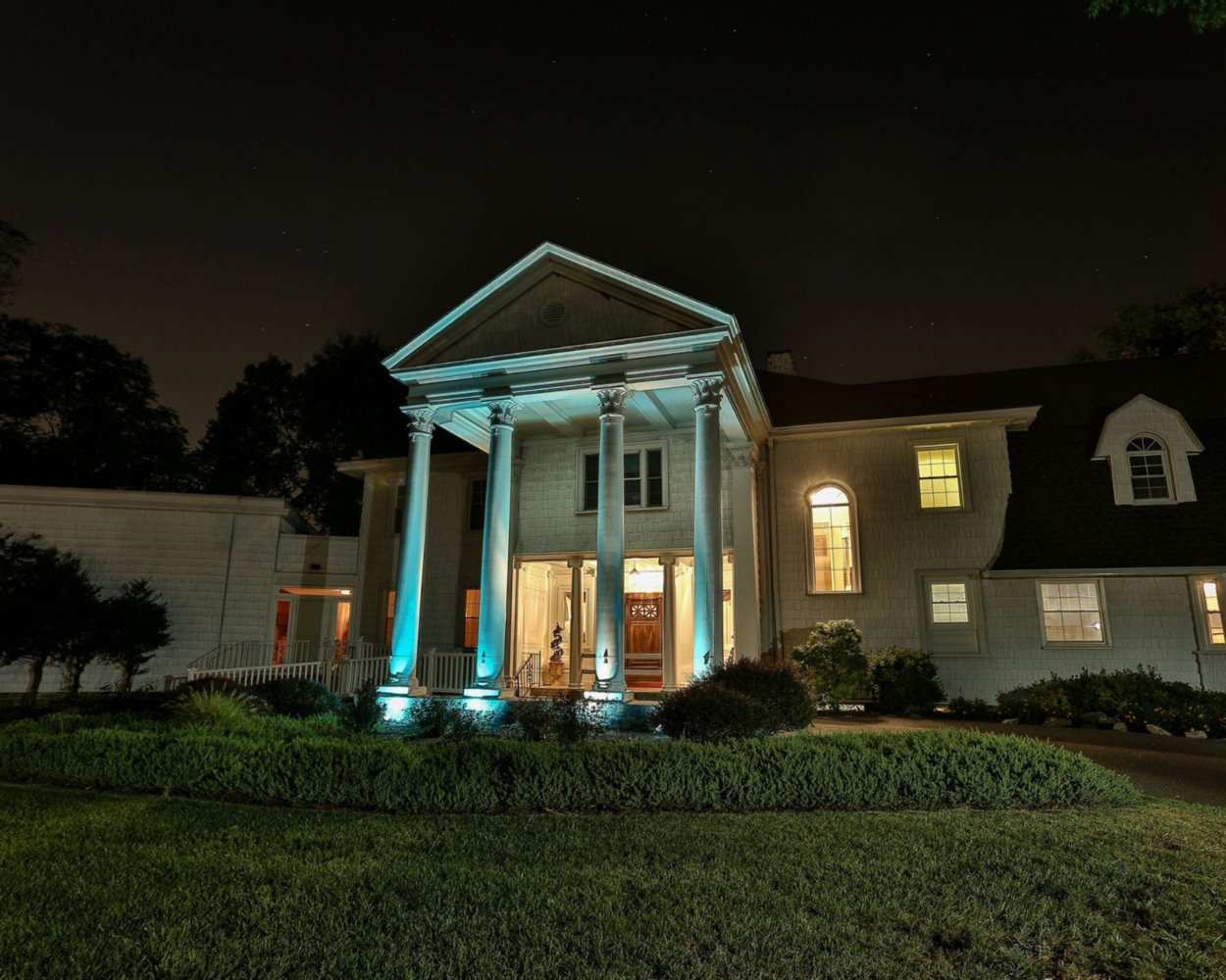 Historic Mansion colonnades at night