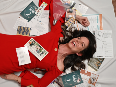 woman in red laying on wedding cards