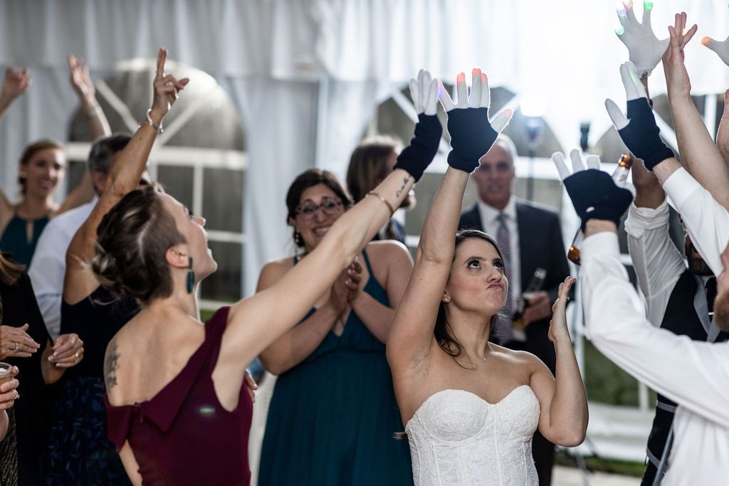 bride and crowd with light up gloves on dance floor