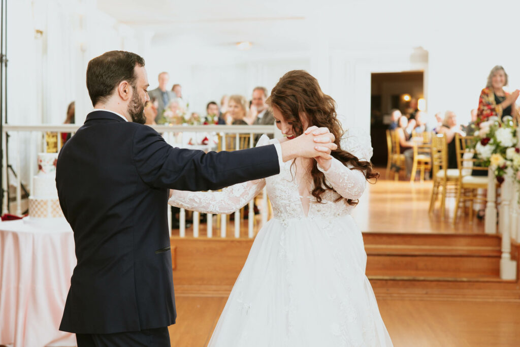bride and groom wedding first dance in bright white room