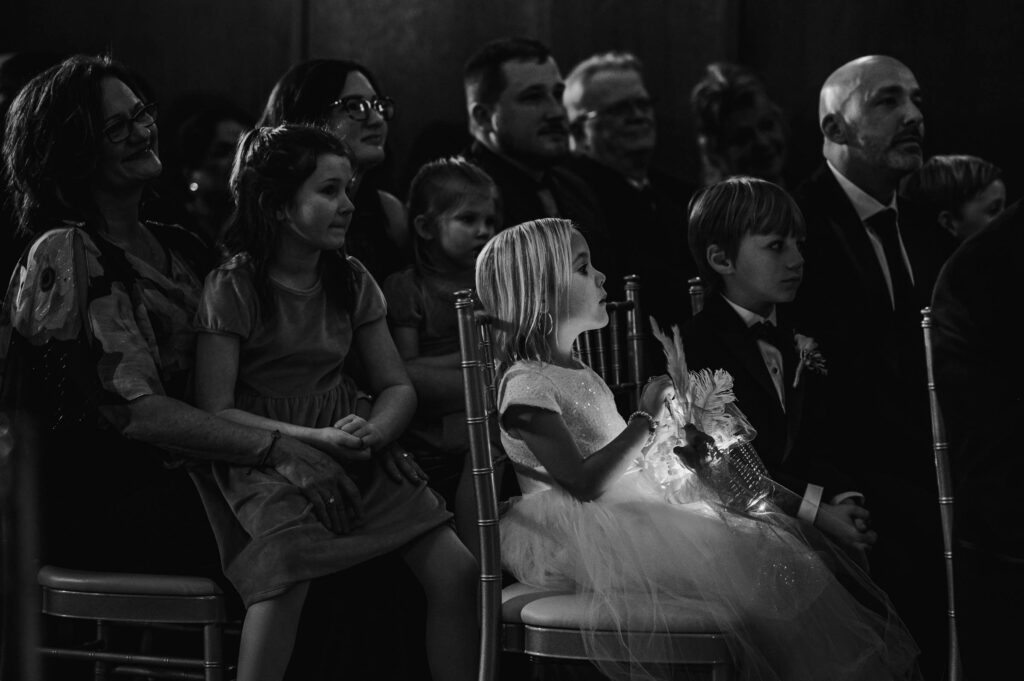 Little kids at wedding ceremony in chairs