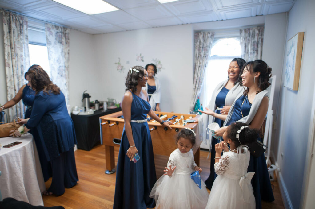 bridal party in blue dresses in game room