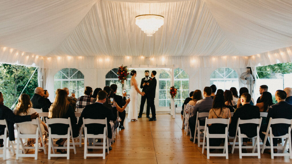 bride and groom vows in white tent