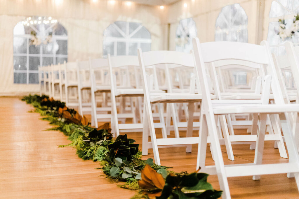 white chairs in white tend, close view
