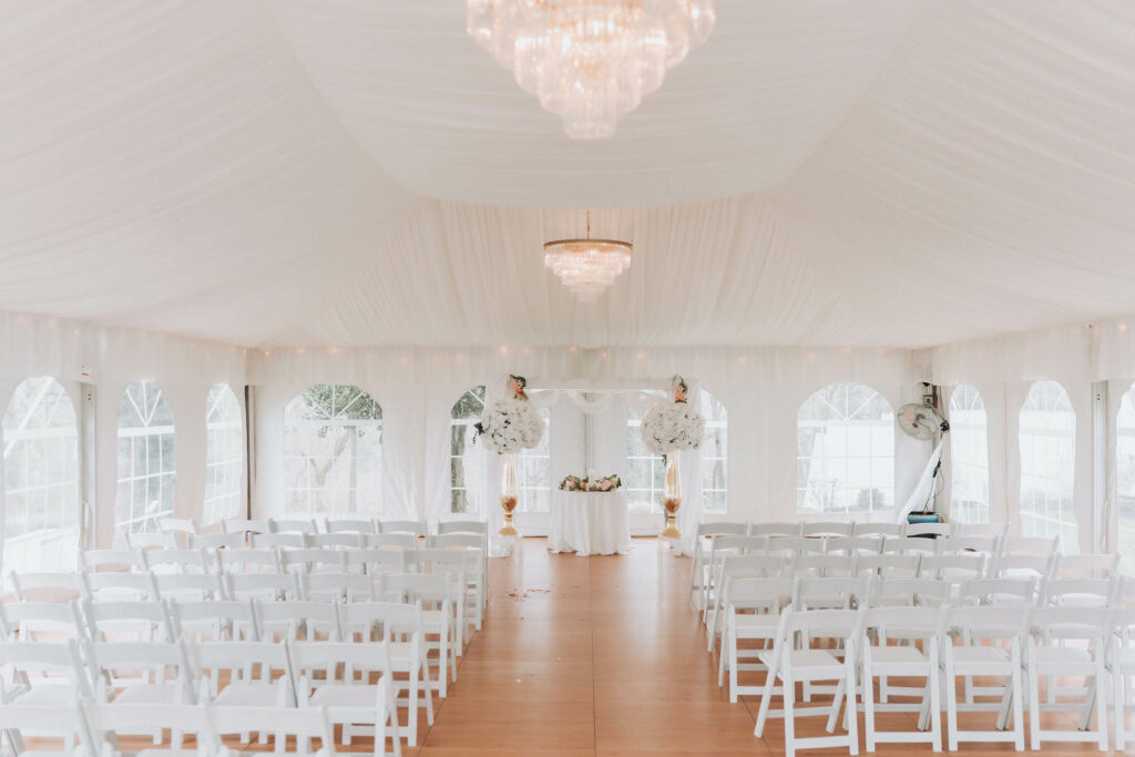 white wedding tent with white chairs