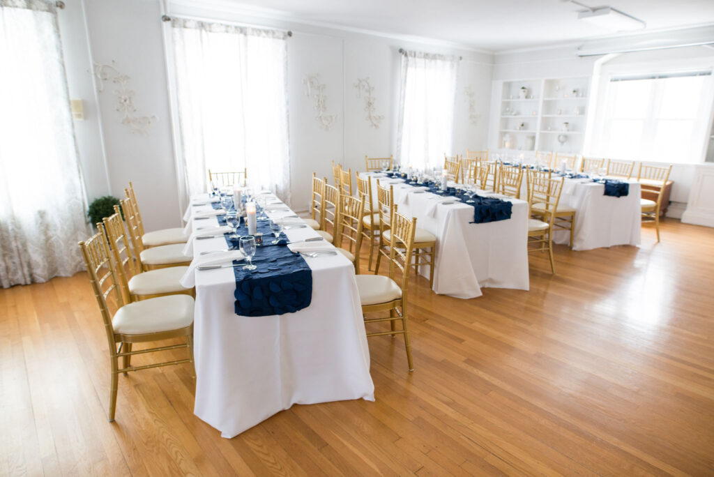 Long tables in bright white grand room