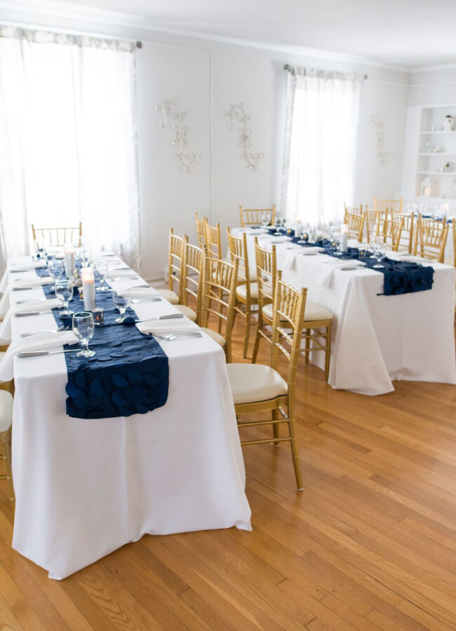 Long tables in bright white grand room